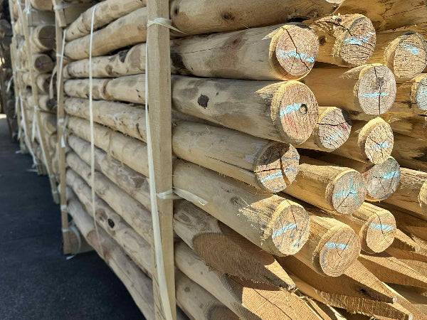 Stapel duurzame Robinia ronde palen diameter 8-10 cm ontschorst en gepunt - Prindal Hout